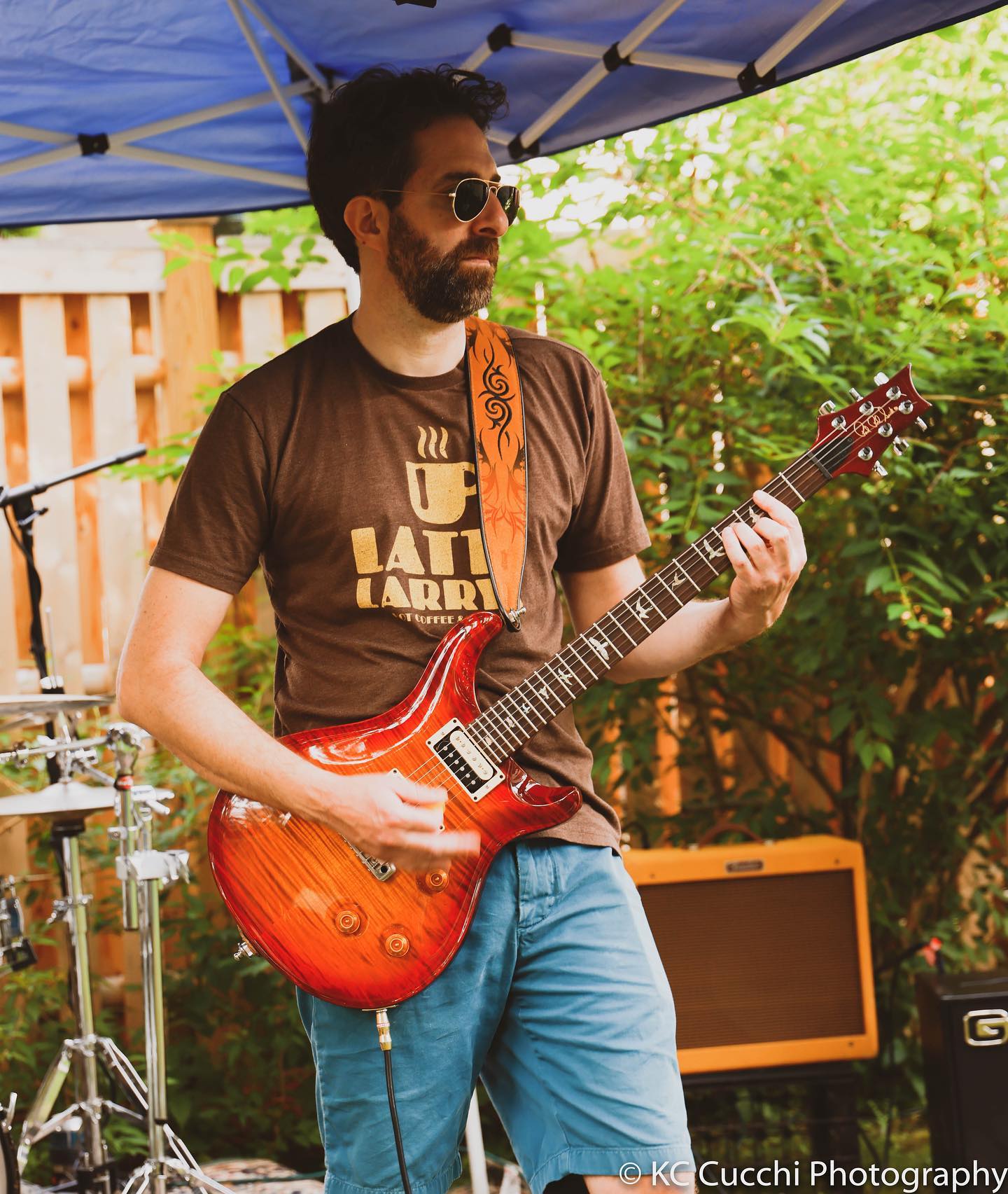 Jamie Bacheller playing guitar at an outdoor show