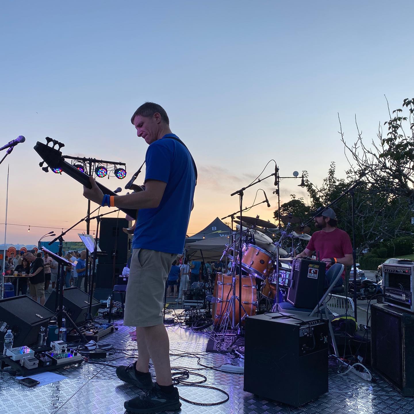 Birdface guitarist performing at sunset